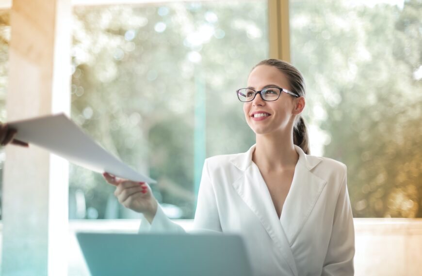 A person looking at her Gallup CliftonStrengths Assessment PDF.